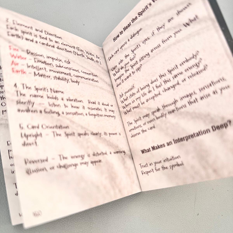 Open book with handwritten notes on a gray surface